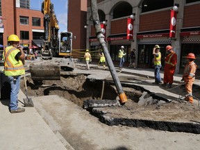 Workers repair a water main break in the ByWard Market in late August 2019.