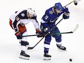 Pierre-Luc Dubois (left) of the Columbus Blue Jackets battles with Brayden Point of the Tampa Bay Lightning for the puck in Game Two of the Eastern Conference First Round during the 2020 NHL Stanley Cup Playoffs at Scotiabank Arena on August 13, 2020 in Toronto, Ontario.