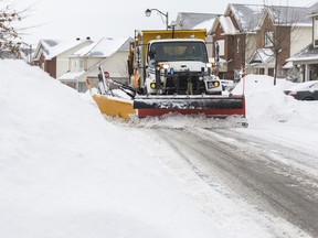 A snowplow clears Beatrice Drive in Barrhaven following a winter storm on Feb. 13, 2019.