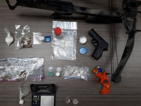 Four people were charged after a raid in Quite West uncovered a quantity of drugs and weapons.