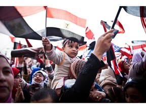 In this file photo from 2014, Egyptians wave the national flag in Cairo's Tahrir Square during a rally marking the anniversary of the 2011 Arab Spring uprising. Today, the country is still under the thumb of an authoritarian government – just a different one.