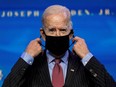 U.S. President-elect Joe Biden removes his mask as he announces members of economics and jobs team at his transition headquarters in Wilmington, Delaware, U.S., January 8, 2021.