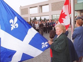Then-Aylmer mayor Constance Provost holds the Quebec flag prior a flag-raising ceremony at Nepean City Hall in 1995.
