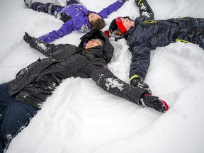 Trina Fraser, chair of The Snowsuit Fund’s volunteer board of directors, along with her children 10-year-old Emmerson and 13-year-old Daxton were having fun making snow angels during last week’s snowstorm.