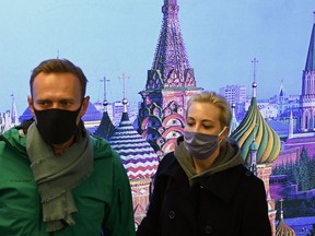 Russian opposition leader Alexei Navalny and his wife Yulia are seen at Moscow's Sheremetyevo airport upon the arrival from Berlin on January 17, 2021.