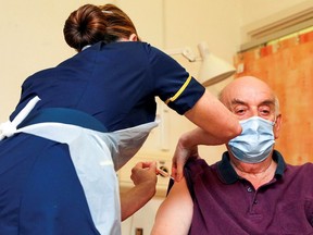 Files: A man, 82, receives the Oxford University/AstraZeneca COVID-19 vaccine from nurse Sam Foster at the Churchill Hospital in Oxford, Britain January 4, 2021.