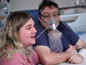 Elizabeth Kerr, 31, and Simon O'Brien, 36, sit beside each other in a COVID-19 ward, days after they married in an ICU (Intensive Care Unit) when both had become critically ill with the coronavirus disease (COVID-19), and were uncertain of their chances of surviving, in Milton Keynes University Hospital, Milton Keynes, Britain, January 20, 2021.