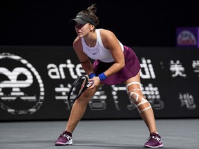 Bianca Andreescu of Canada is seen with a bandaged in her knee during her women's singles match against Karolina Pliskova of Czech Republic during their women's singles match at the WTA Finals tennis tournament in Shenzhen on October 30, 2019.