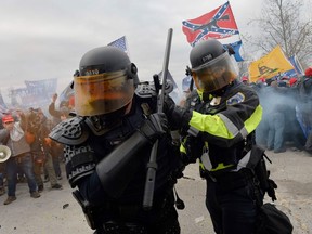 Trump supporters clash with police and security forces as they try to storm the US Capitol in Washington, DC on January 6, 2021. - Demonstrators breeched security and entered the Capitol as Congress debated the a 2020 presidential election Electoral Vote Certification.