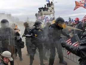 TOPSHOT - Trump supporters clash with police and security forces as they try to storm the US Capitol in Washington, DC on January 6, 2021. -