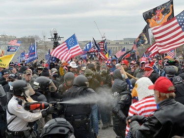 Trump supporters clash with police and security forces as people try to storm the US Capitol Building in Washington, DC, on January 6, 2021. - Demonstrators breeched security and entered the Capitol as Congress debated the a 2020 presidential election Electoral Vote Certification. (Photo by Joseph Prezioso / AFP)