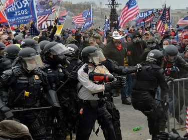Trump supporters clash with police and security forces as they try to storm the US Capitol in Washington, DC on January 6, 2021. - Demonstrators breeched security and entered the Capitol as Congress debated the a 2020 presidential election Electoral Vote Certification. (Photo by Joseph Prezioso / AFP)