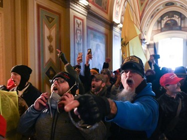 TOPSHOT - Supporters of US President Donald Trump protest inside the US Capitol on January 6, 2021, in Washington, DC. - Demonstrators breeched security and entered the Capitol as Congress debated the a 2020 presidential election Electoral Vote Certification. (Photo by ROBERTO SCHMIDT / AFP)