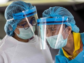 FILE: Medical workers wearing personal protective equipment.