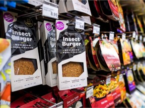 (FILES) In this file photo taken on August 21, 2017, packs of pre-cocked insect burgers based on protein-rich mealworm are seen on a supermarket shelf in Geneva.