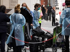 Tennis players, coaches and officials arrive at a hotel in Melbourne on January 15, 2021, before quarantining for two weeks ahead of the Australian Open tennis tournament.