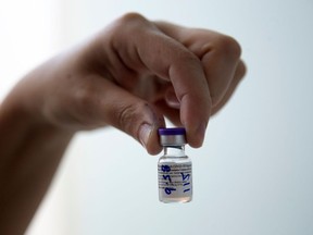 FILE: A nurse holds a vial of a Pfizer-BioNTech Covid-19 vaccine.