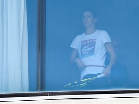 An unidentified tennis player exercises in her hotel room in Melbourne in January 17, 2021, where players are quarantining for two weeks ahead of the Australian Open tennis tournament.