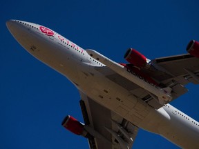 The Virgin Orbit "Cosmic Girl" — a modified Boeing Co. 747-400 carrying a LauncherOne rocket under it's wing — takes off for the Launch Demo 2 mission from Mojave Air and Space Port on January 17, 2021 in Mojave, California.