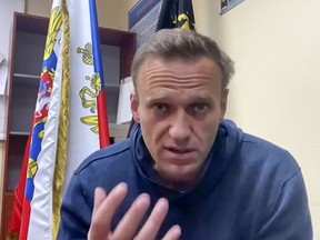 Files: - This screen capture taken from a video made available on January 18, 2021 on Navalny team Youtube page shows Russian opposition leader Alexei Navalny speaking while waiting for a court hearing at a police station in Khimki outside Moscow. -