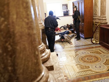 U.S. Capitol Police hold protesters at gun-point near the House Chamber inside the U.S. Capitol on Wednesday, Jan. 6, 2021, in Washington.