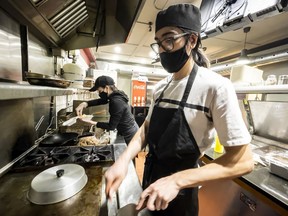 Shibayan co-owner Eric Carbonneau-Shibata and his life partner, Anaëlle Charlebois-Piché, prepare food in the Sunnyside Avenue restaurant. Carbonneau-Shibata had been a croupier at the Casino du Lac-Leamy, but he was laid off last March when the COVID-19 curtain came down.