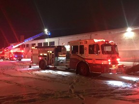 Firefighters extinguish a fire in an Industrial Avenue warehouse on Tuesday.