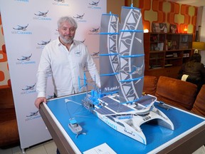 Franco-Swiss skipper and founder of 'The SeaCleaners' NGO, Yvan Bourgnon, poses next to a model of the 'Manta', a giant sailing boat which will collect and recycle the oceans' floating plastic waste, during an interview with Reuters in Paris, France, January 26, 2021.