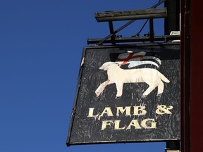 A sign for The Lamb and Flag is seen as the Grade-II listed pub is forced to close, after more than 400 years of business, following outbreak of the coronavirus disease (COVID-19) pandemic, in central Oxford, Britain, January 25, 2021.