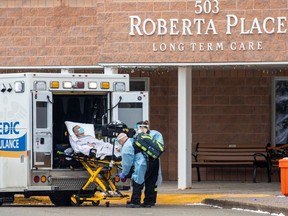 Files: Paramedics transport a person from Roberta Place, a long term seniors care facility which was the site of a coronavirus disease (COVID-19) outbreak, in Barrie, Ontario, 
on January 18, 2021.