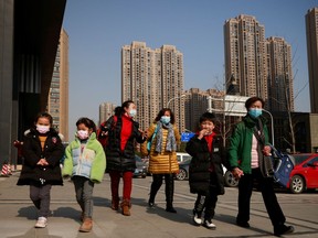 Women walk with children after picking them up from a nearby primary school following the outbreak of the coronavirus disease (COVID-19) in Wuhan, Hubei province, China, January 15, 2021.