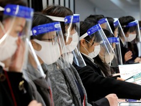 FILE PHOTO: Staff wearing protective face shields amid the coronavirus disease outbreak
