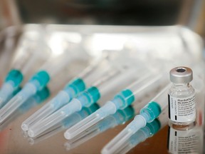 FILE PHOTO: Syringes and a dose of the Pfizer-BioNTech COVID-19 vaccine