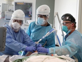 FILE PHOTO: Dr. Dan Ponticiello, 43, and Dr. Gabriel Gomez, 40, intubate a coronavirus disease (COVID-19) patient in the COVID-19 ICU at Providence Mission Hospital in Mission Viejo, California, U.S., January 8, 2021.