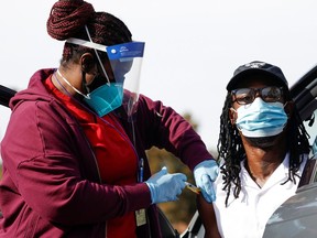 Nurse Dawn Duran administers a dose of the Moderna COVID-19 vaccine to Jeremy Coran during the outbreak of the coronavirus disease (COVID-19), in Pasadena, California, U.S., January 12, 2021.