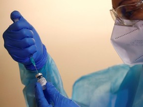 A member of a vaccination team prepares a dose.