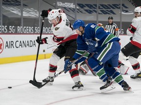 Vancouver Canucks forward Jay Beagle checks Ottawa Senators defenceman Mike Reilly in the first period at Rogers Arena on Wednesday
