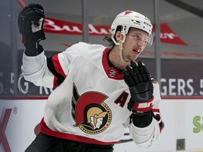 Senators defenceman Thomas Chabot celebrates after scoring a goal against the Canucks on Thursday. Chabot crashed into the net in the third period and his availability for Sunday's contest against the Oilers won't be determined until after the morning skate.