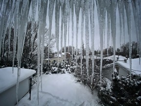 Icicles hang off a roof during a freezing cold afternoon in Ottawa, Friday, January 22, 2021.
