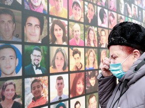 A victim's relative mourns during a commemorative ceremony, which marks the first anniversary of the Ukraine International Airlines flight PS752 downing in Iranian airspace, in Kyiv, Ukraine January 8, 2021.