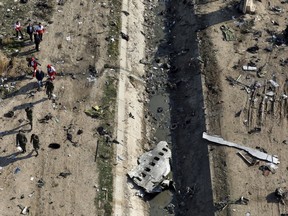 Rescue workers search the scene where a Ukrainian plane crashed in Shahedshahr, southwest of the capital Tehran, Iran, on January 8, 2020.