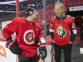 Senators' owner Eugene Melnyk chats with defenceman Thomas Chabot at a holiday-season event in 2019.