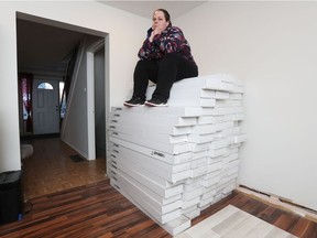 Brigitte McCauley-Philion poses with her new flooring at her home in Ottawa on Friday.