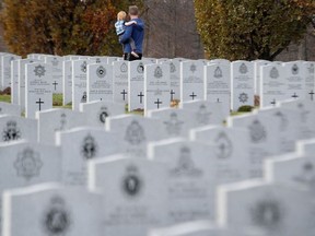A father and son visit the National Military Cemetery at Beechwood Cemetery in Ottawa.