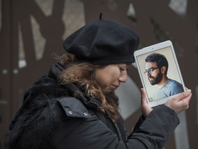 Maral Gorginpour stands out front of her Toronto home with a portrait of her husband who was killed when Ukraine International Airlines Flight PS752 was shot down by the Iranian military days after the couple were married.