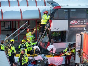 First responders attend to victims of a rush-hour bus crash at the Westboro Station in January 2019.