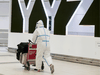 File: A passenger is covered head to toe at the international arrivals area at Pearson International Airport on January 26, 2021.