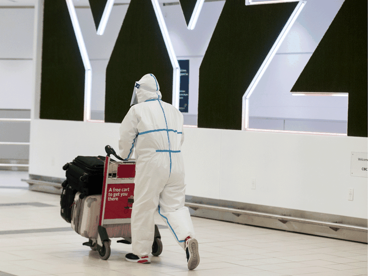  File: A passenger is covered head to toe at the international arrivals area at Pearson International Airport on January 26, 2021.