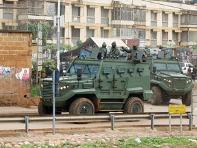 Military APC's (Armoured Personal Career) patrol before announcement of the winner of the Ugandan presidential elections, in Kampala, Uganda on Saturday.