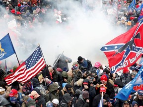 FILE PHOTO: Tear gas is released into a crowd of protesters during clashes with Capitol police at a rally to contest the certification of the 2020 U.S. presidential election results by the U.S. Congress, at the U.S. Capitol Building in Washington, U.S, January 6, 2021.